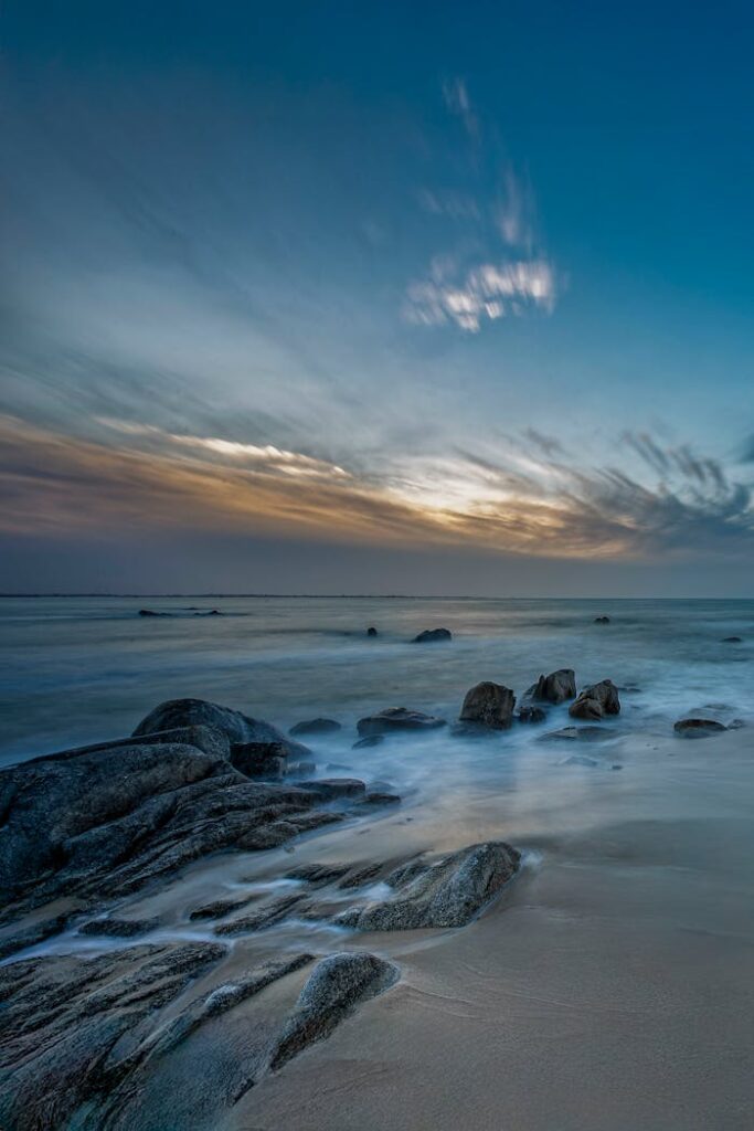 pexels photo 33391207 Tranquil sunset over a rocky coastline in Bretagne, France, captured with smooth waves and vibrant sky.